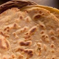 Lachha Paratha · Whole wheat layered bread baked with butter in the tandoor.