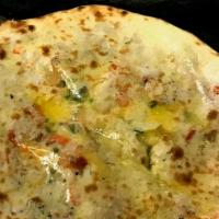 Chicken And Cheese Naan · Minced chicken with cheese topped on white flour bread baked in clay oven.