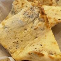 Kashmiri Naan · White flour bread baked with dried fruits, nuts and raisins.