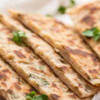 Onion Kulcha · Whole flour bread baked with finely chopped onions and spices.