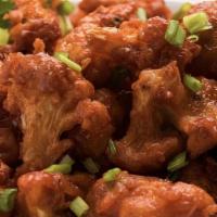 Gobi Manchurian (Vegan) · Deep-fried cauliflower fritters mixed in a spicy and tangy sauce.