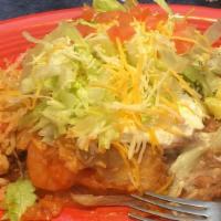 Shrimp Chimichanga · Burrito topped with Guacamole, Sour Cream, Lettuce, Tomatoes, and Cheese.