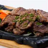 Galbee Gooyi · Thinly sliced short ribs marinated and broiled.