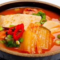 Kimchi Jigae · Kichi and sliced pork stew with tofu, sliced rice cakes and vegetables in spicy sauce. Hot a...