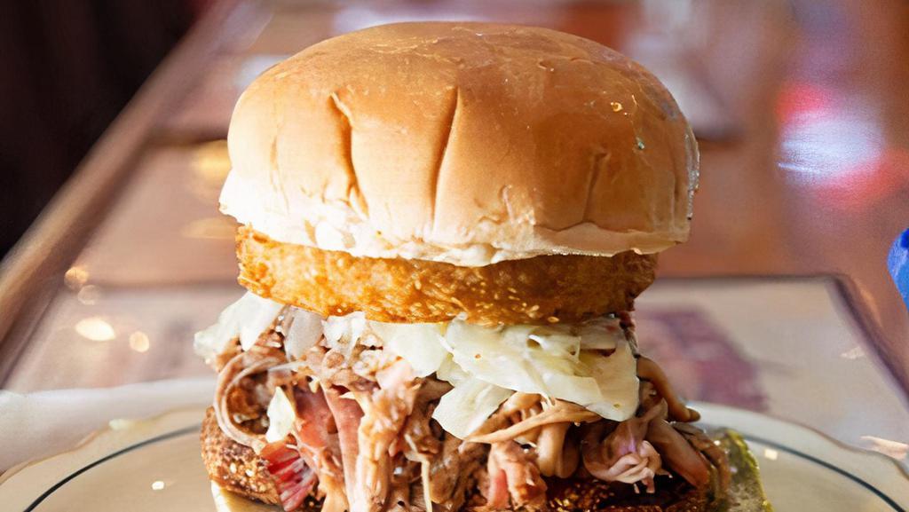 Sweeney'S Southern Pulled Pork Sandwich · A toasted Roma bun layered with pulled pork, onion ring, and topped with vinegar based coleslaw.