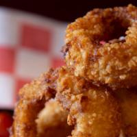 World Famous Onion Rings · Thick cut rings, egg batter dipped, and rolled in crushed cracker crumbs.
