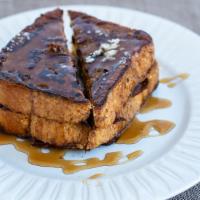 French Toast · Two slices of thick French toast with butter and syrup.