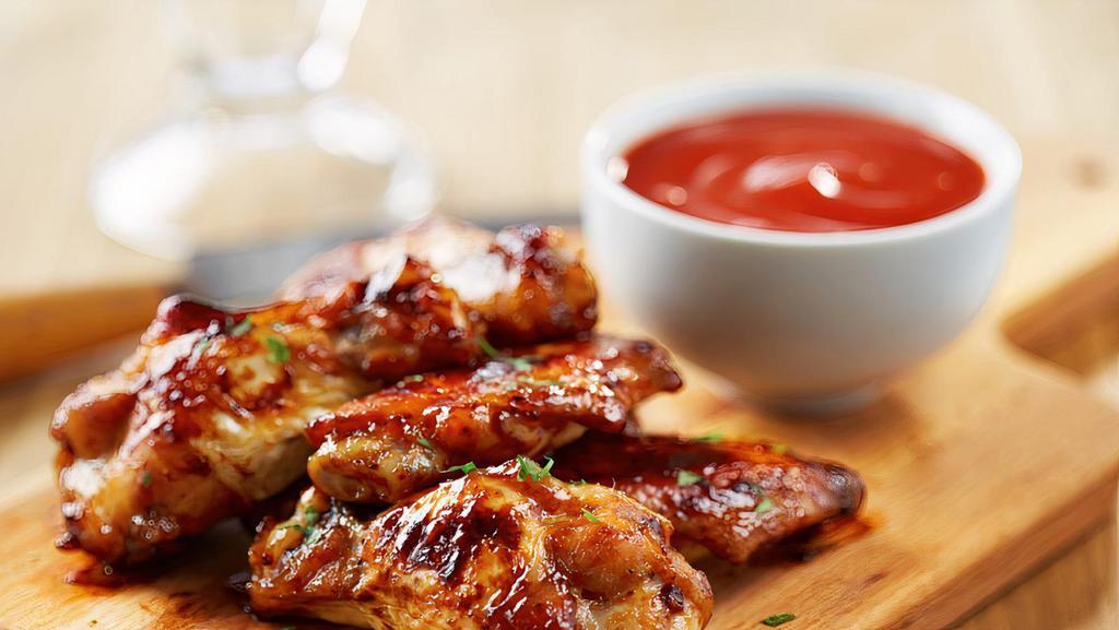Honey Bbq Wings · 6 bone-in honey BBQ chicken wings. Served with celery, carrots, and blue cheese or ranch dressing.