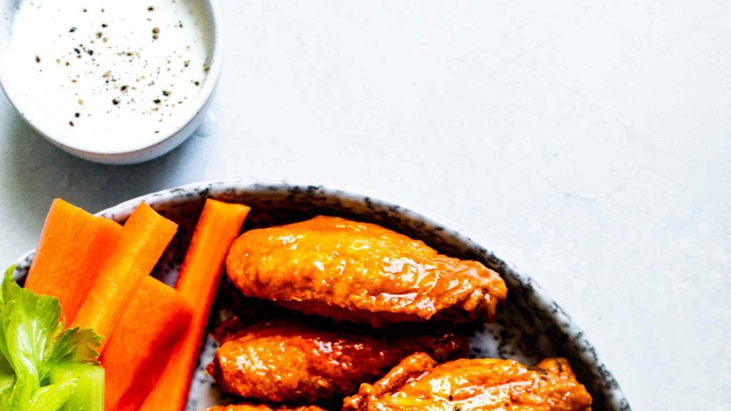 Buffalo Medium Wings · 6 bone-in medium chicken wings. Served with celery, carrots and blue cheese or ranch dressing.
