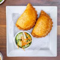 Curry Puffs · Crispy puffs stuffed with curried potatoes, onions, chicken, & served with cucumber chutney....
