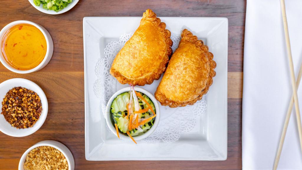 Curry Puffs · Crispy puffs stuffed with curried potatoes, onions, chicken, & served with cucumber chutney. (2 puffs).