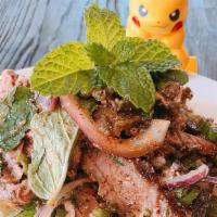 Crying Tiger Salad · (Spicy). sliced steak, red onions, cilantro, mint, rice powder, herbs, and chili tossed in l...