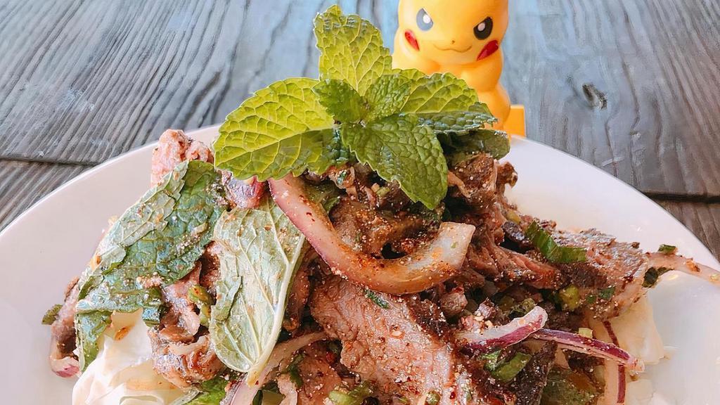Crying Tiger Salad · (Spicy). sliced steak, red onions, cilantro, mint, rice powder, herbs, and chili tossed in lime sauce. contains raw or undercooked food.