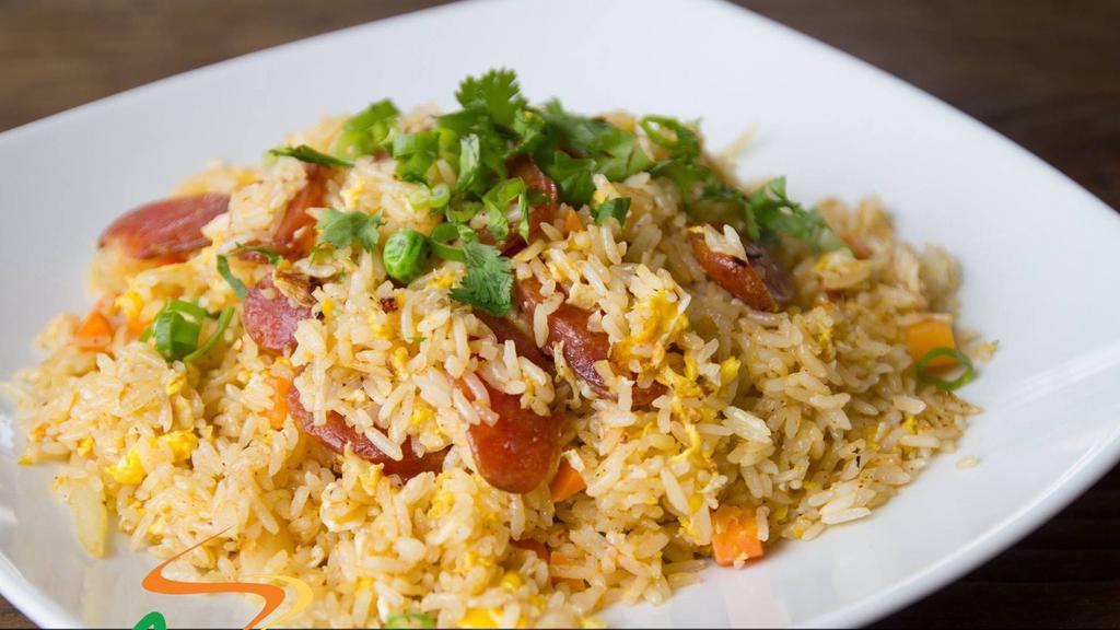 Sausage Fried Rice · Jasmine rice stir-fried with egg. Thai sausage, peas, carrots, and onion. Fried rice dishes are cooked to order.