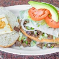 Torta · Sandwich served on a Mexican style Telera roll with your choice of Meat, Refried Beans, Onio...