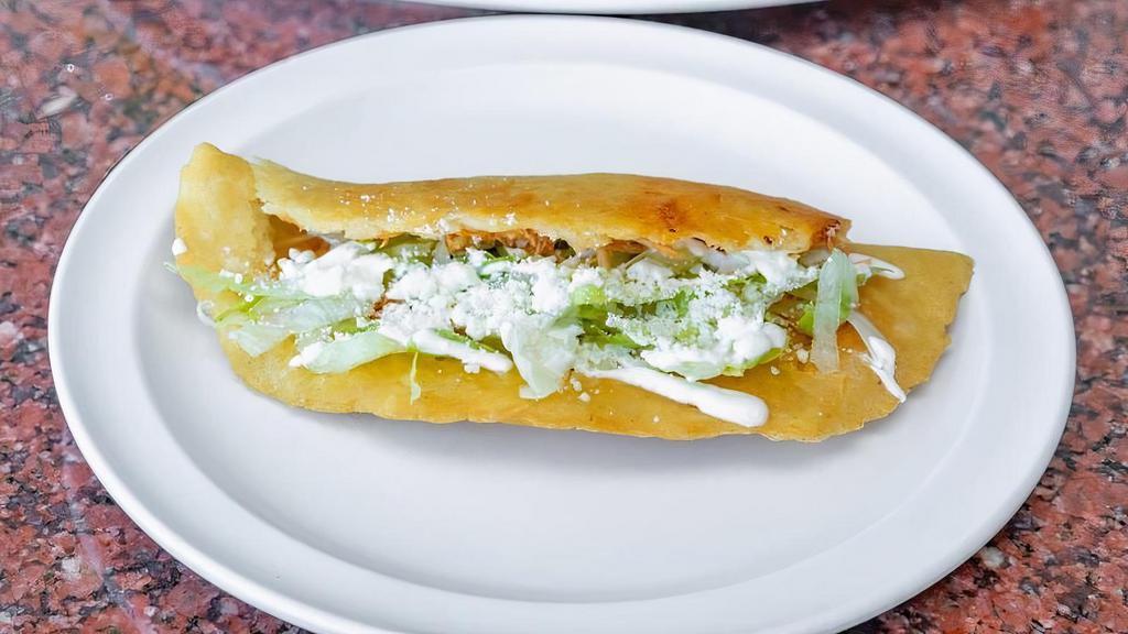 Quesadilla · Folded, pan-fried Corn Tortilla of handmade dough with your choice of Filling, Lettuce, Cotija Cheese & Sour Cream