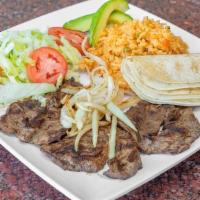 Grilled Steak · Fresh cuts of Skirt Steak seasoned and grilled with Onions served with (5) Corn Tortillas an...