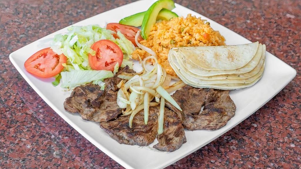 Grilled Steak · Fresh cuts of Skirt Steak seasoned and grilled with Onions served with (5) Corn Tortillas and (2) Sides