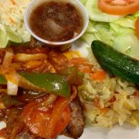 Bistek De Carne / Steak Sautéed With Onions & Tomato · acompanada con arroz, frijoles, ensalada rusa, pico de gallo, chile toreado, aguacate,  y tr...