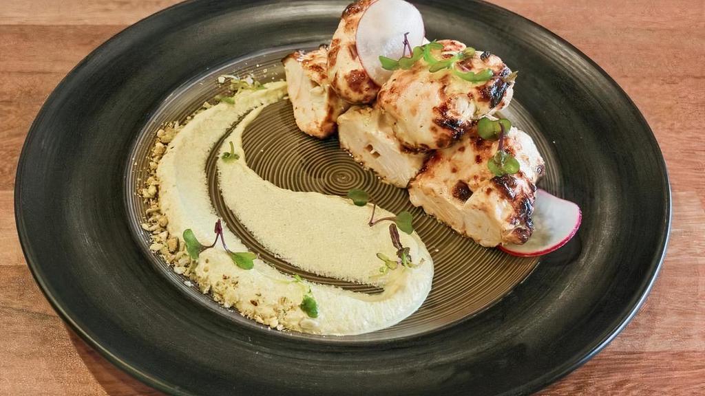 Chicken Malai Tikka · Chicken tenders marinated in cream cheese, grilled in tandoor and garnished with creamy pistachio puree, pine nuts and pumpkin seeds