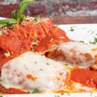 Chicken Parmigiana · Battered in eggs, topped with tomato sauce and Mozzarella cheese. Served with a side spaghet...