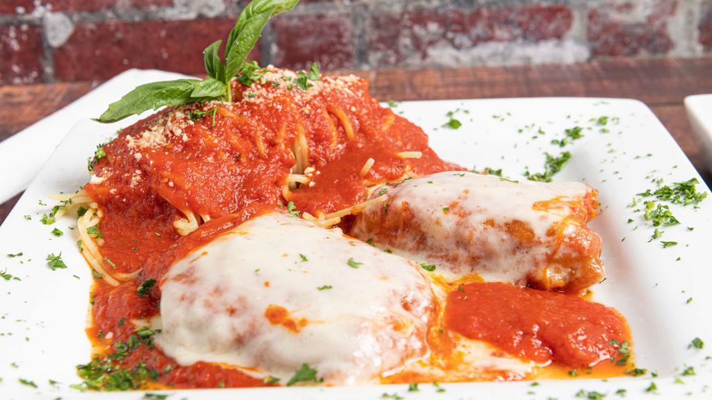 Chicken Parmigiana · Battered in eggs, topped with tomato sauce and Mozzarella cheese. Served with a side spaghetti.