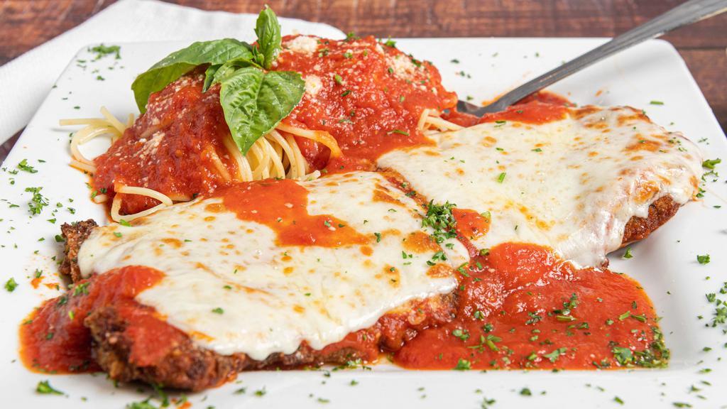 Veal Parmigiana · Battered in eggs, topped with tomato sauce and mozzarella cheese. Served with a side of spaghetti.
