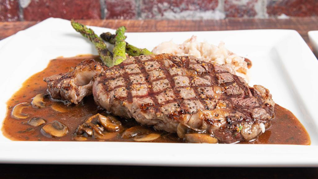 Rib Eye · A 14 oz Angus rib-eye center cut steak seasoned with sea salt and mixed herbs, grilled drizzled with a rich demi-glace sauce. Served with mushrooms and mashed potato.