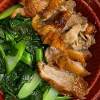 Roast Duck Rice · Roast Duck over jasmine rice and yu choy, topped with a savory duck sauce and fried garlic