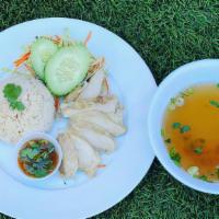 Hainan Chicken Rice · Steamed chicken over jasmine rice topped with cilantro and ginger sauce