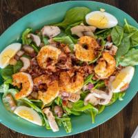 Blackened Shrimp And Spinach Salad · Fresh baby spinach topped with blackened shrimp, bacon, fresh mushrooms, red onion, pine nut...
