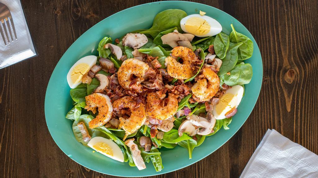 Blackened Shrimp And Spinach Salad · Fresh baby spinach topped with blackened shrimp, bacon, fresh mushrooms, red onion, pine nuts, and egg. Substitute blackened or fried catfish upon request.