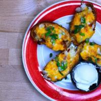Irish Potato Skins · Topped with mashed potatoes, cheese & bacon; served with sour cream.