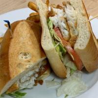 Beer Battered Fish Sandwich · Galway Bay beer-battered cod, shredded lettuce, tomatoes & tartar sauce; served on a long ro...