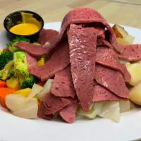 Corned Beef & Cabbage · Drizzled with butter & served with cabbage, red potatoes & seasonal vegetables.
