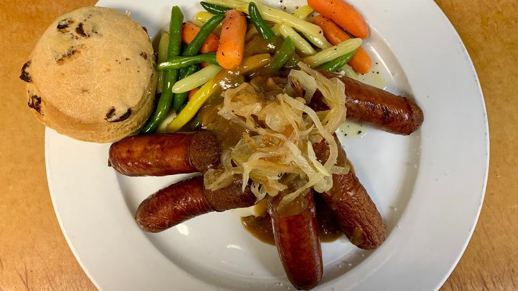 Bangers & Mash · Irish pork sausages & mashed potatoes; topped with brown gravy & sautéed onions; served with seasonal vegetables & a buttered Irish scone.