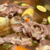Caldo De Res · Beef soup with squash, zucchini, cabbage, potato, carrots and corn.