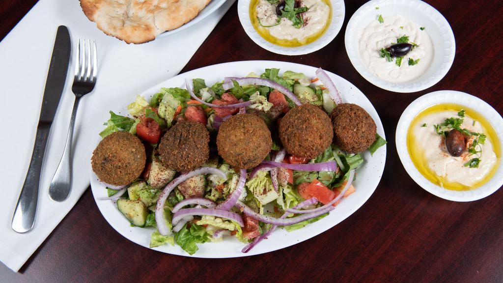 Falafel Platter · Chick pea croquet (5) golden fried served with salad, hummus, Baba ghanouj, tahini and naan bread.