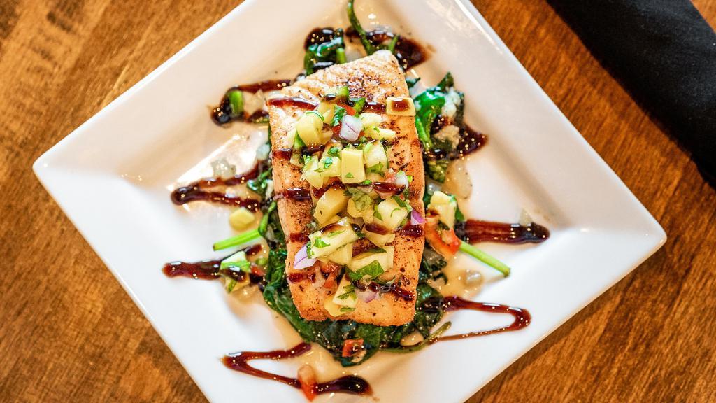 Blackened Salmon · Served over sautéed spinach topped with our pineapple salsa and a balsamic reduction.
