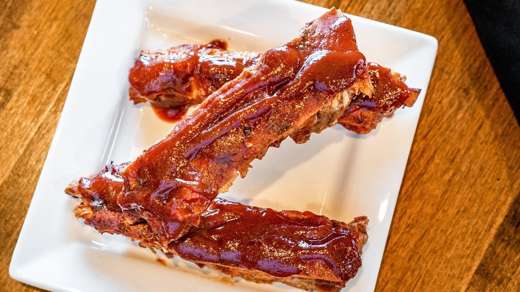 Kc/Stl Style Spare Ribs · a half-pound (3-4 ribs) slow braised and then grilled over our wood-burning fire and covered in our Kanas City style BBQ sauce.