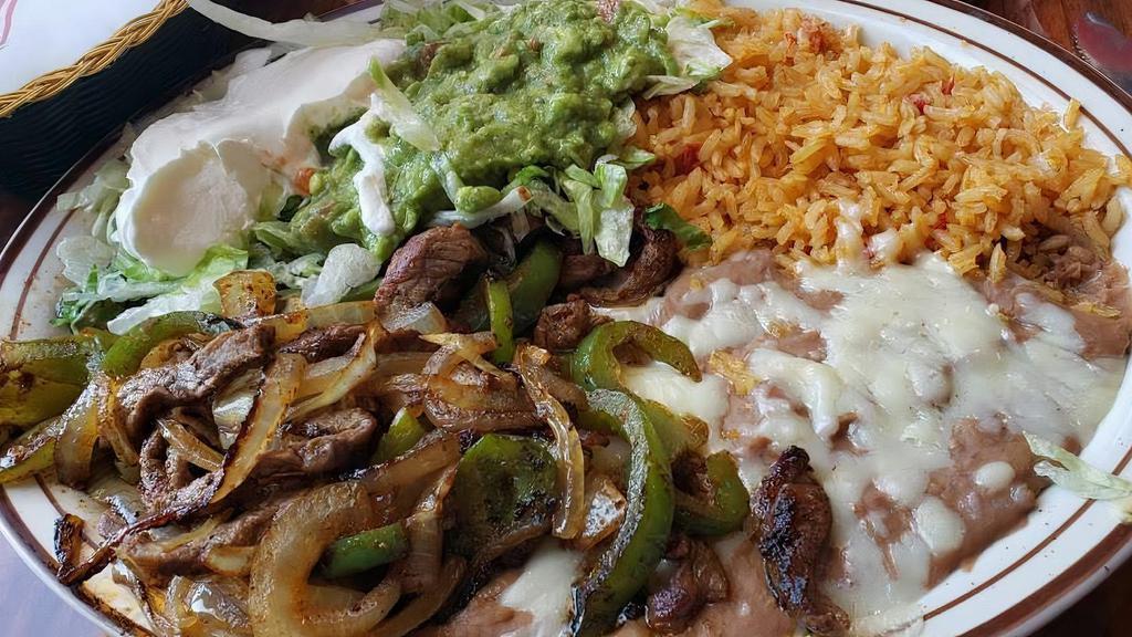 Fajitas Express · Our version of tender slices of beef or chicken grilled with onions and bell peppers. Served with flour tortillas, beans, lettuce, tomatoes, sour cream, guacamole and rice.