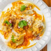 Mantu · Homemade pastry shells filled with onions and beef, served on yogurt and topped with carrots...