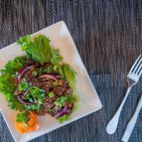 Num Tok (Beef Salad) · Grilled sliced beef tossed with roasted chili peppers, red onions, scallions, cilantro, and ...