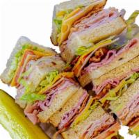 The Club · Boring but beautiful. Turkey, ham, Swiss and American layered on white toast with lettuce, t...