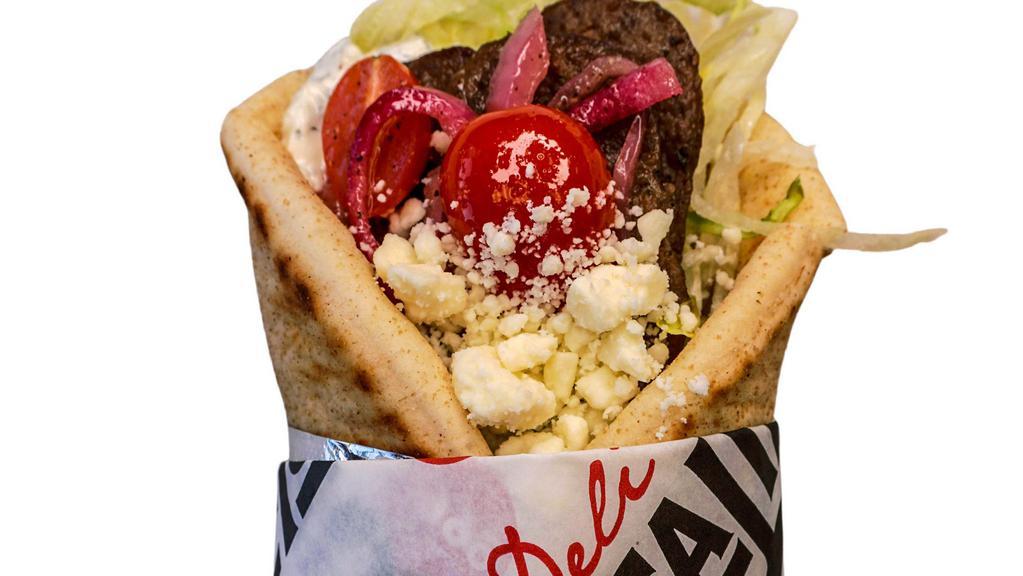 Beef Gyro · Seasoned beef, lettuce, feta, marinated cherry tomato and red onion, with cucumber tzatziki, on grilled pita.