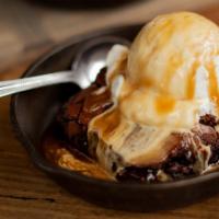 Brownie A La Mode · Rich fudge brownie served warm with a scoop of vanilla bean ice cream and topped with carame...