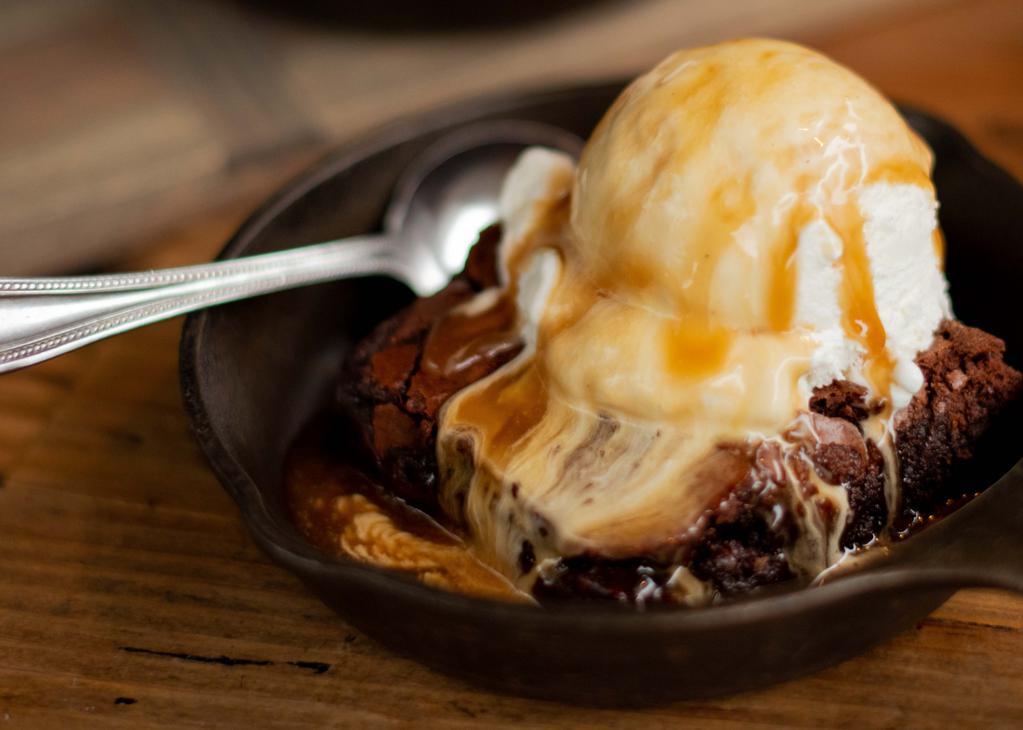Brownie A La Mode · Rich fudge brownie served warm with a scoop of vanilla bean ice cream and topped with caramel sauce.