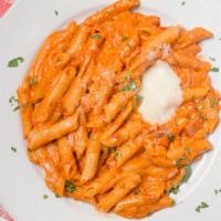 Penne Vodka · Penne vodka in a pink vodka sauce with ham and onions.