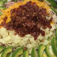 Cobb Salad · Baked chicken breast, ham, turkey, crumbled bacon, avocado, egg, Swiss, Cheddar and Bleu che...