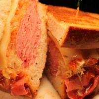 Corned Beef Reuben · Hot. Thinly-sliced corned beef, sauerkraut, Swiss cheese, and Russian dressing on grilled rye.